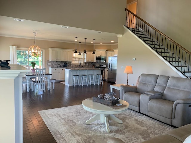 208 Reardon, Rehobeth, AL 36301 - living area with stairs, a chandelier, dark wood-type flooring, crown molding, and recessed lighting