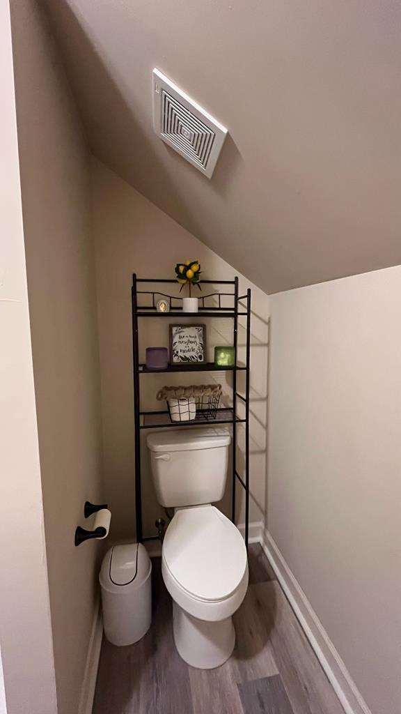 208 Reardon, Rehobeth, AL 36301 - bathroom with toilet, lofted ceiling, wood finished floors, and baseboards
