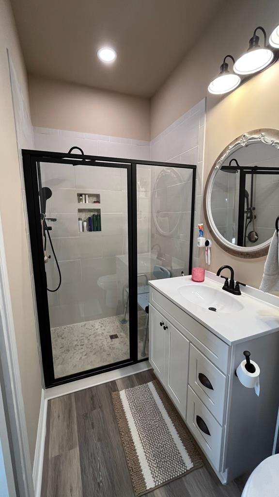 208 Reardon, Rehobeth, AL 36301 - full bath with a shower stall, wood finished floors, vanity, toilet, and recessed lighting