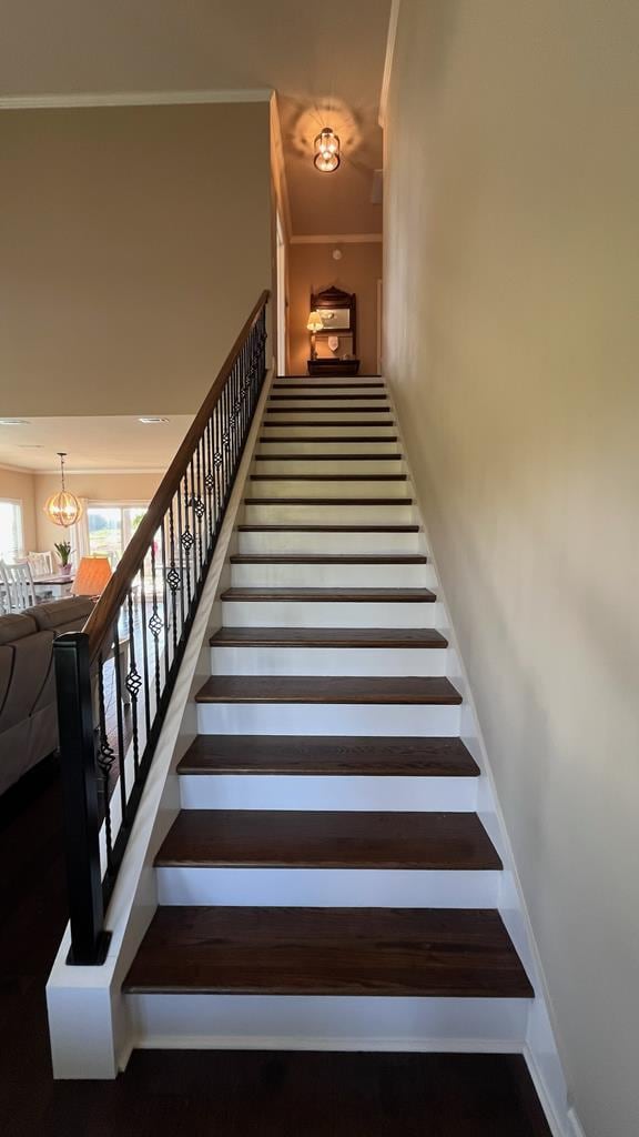 208 Reardon, Rehobeth, AL 36301 - stairway with crown molding, a chandelier, and baseboards