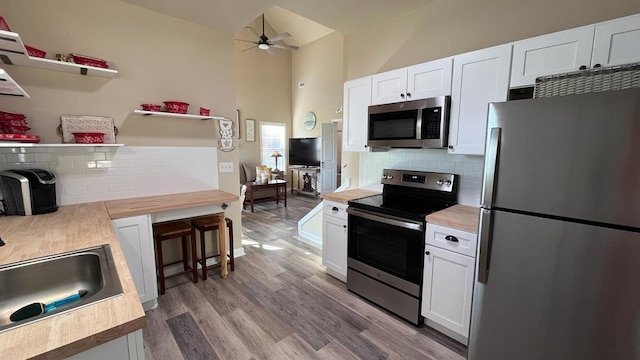 208 Reardon, Rehobeth, AL 36301 - kitchen featuring stainless steel appliances, a ceiling fan, decorative backsplash, white cabinetry, and high vaulted ceiling