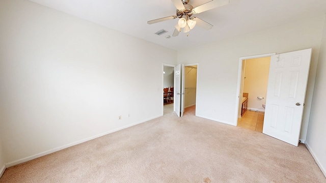 106 Whitney Ave, Enterprise, AL 36330 - unfurnished bedroom with light colored carpet, a spacious closet, connected bathroom, and baseboards