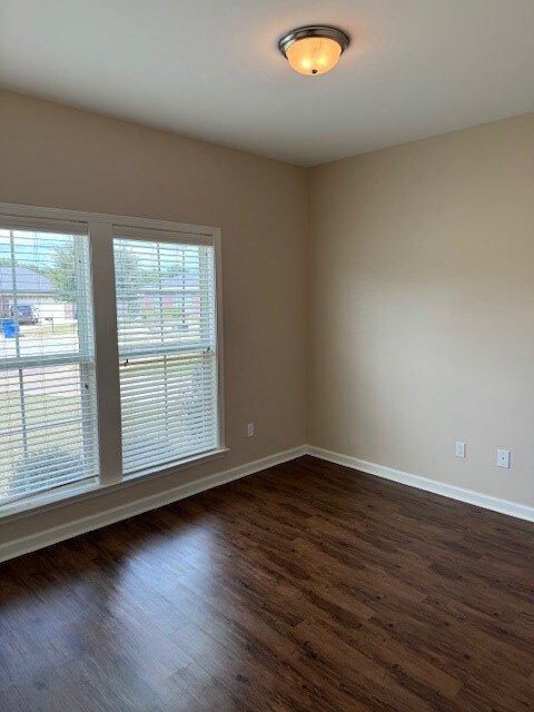 spare room featuring dark hardwood / wood-style floors