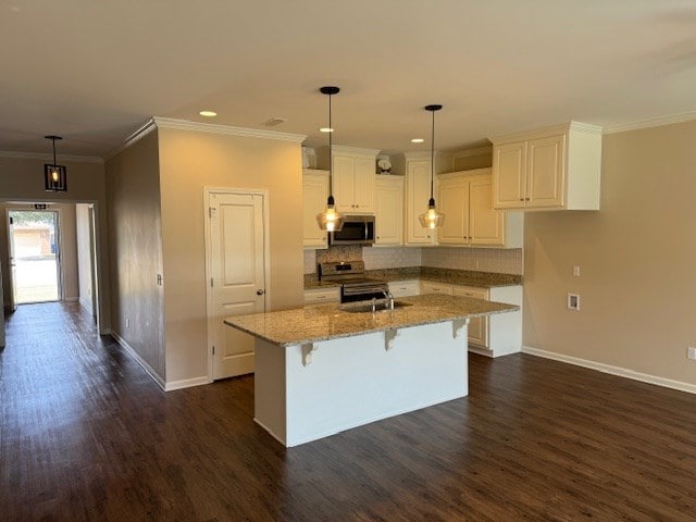 kitchen featuring stainless steel appliances, light stone counters, dark hardwood / wood-style floors, a breakfast bar area, and white cabinets