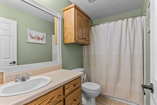 24 County Road 278, Enterprise, AL 36330 - bathroom featuring a textured ceiling, tile patterned floors, toilet, vanity, and a shower with curtain