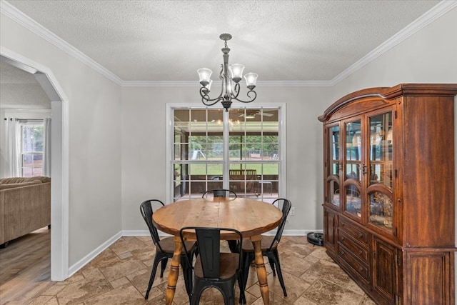 24 County Road 278, Enterprise, AL 36330 - dining room featuring a chandelier, stone tile flooring, ornamental molding, arched walkways, and a textured ceiling