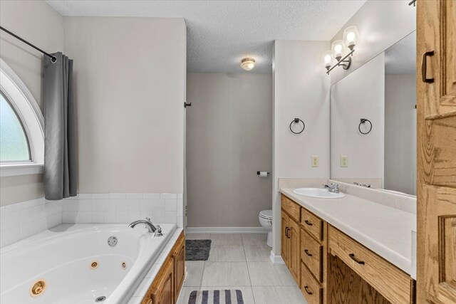 24 County Road 278, Enterprise, AL 36330 - bathroom featuring toilet, a tub with jets, vanity, baseboards, and tile patterned flooring