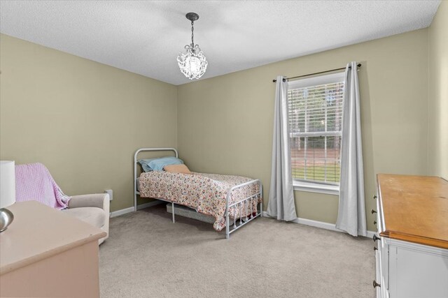 24 County Road 278, Enterprise, AL 36330 - bedroom with light carpet, baseboards, a textured ceiling, and a chandelier