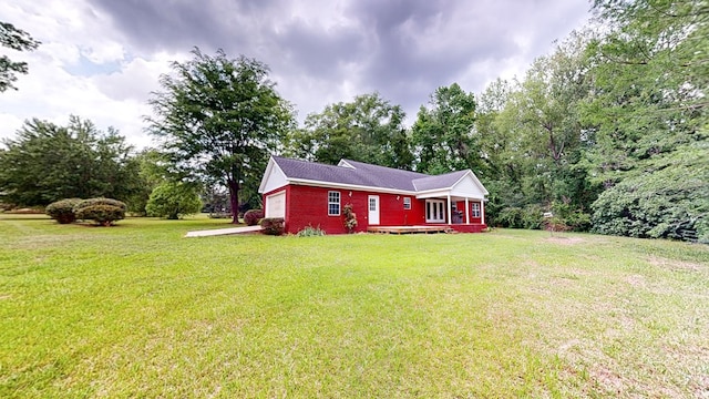 exterior space featuring a front lawn, brick siding, and an attached garage