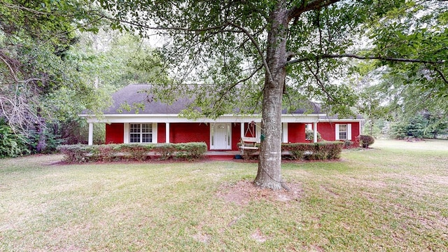 single story home featuring a front yard, covered porch, and brick siding