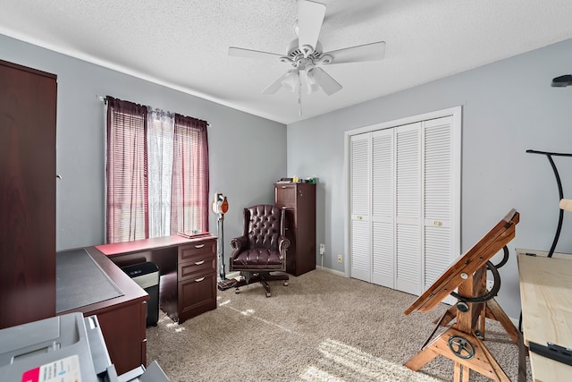 home office with ceiling fan, a textured ceiling, and light colored carpet