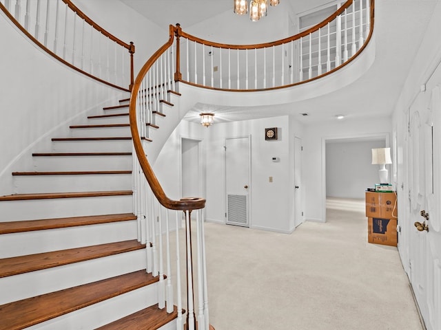 205 W Sand Creek Rd, Enterprise, AL 36330 - stairs with a high ceiling, carpet floors, and a chandelier