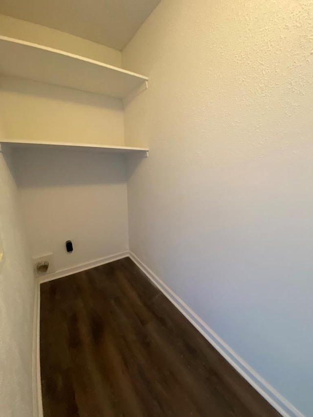 laundry room featuring hookup for an electric dryer and dark wood-type flooring