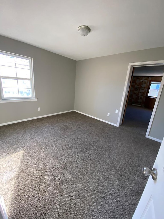 empty room with dark carpet