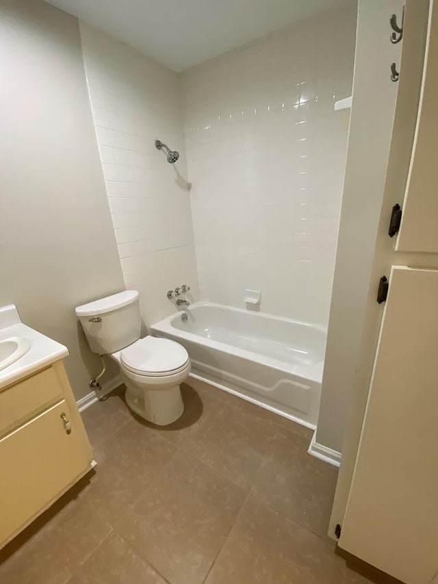 full bathroom with vanity, tiled shower / bath combo, toilet, and tile patterned flooring