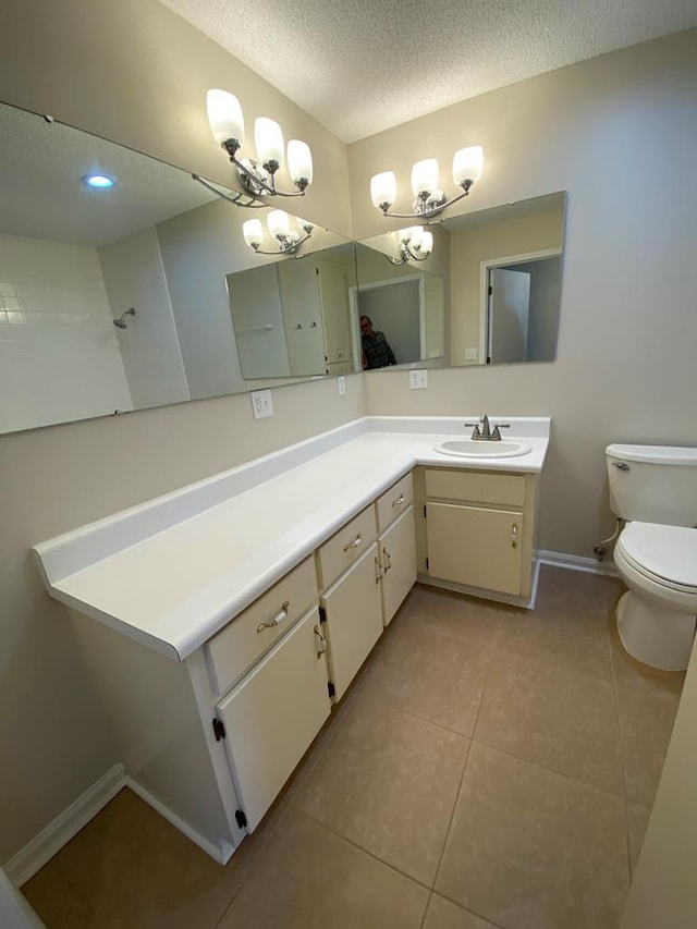 bathroom with vanity, tile patterned floors, toilet, a textured ceiling, and a chandelier