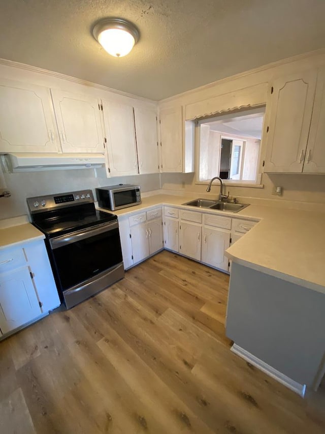 kitchen featuring white cabinetry, sink, light hardwood / wood-style floors, a textured ceiling, and appliances with stainless steel finishes