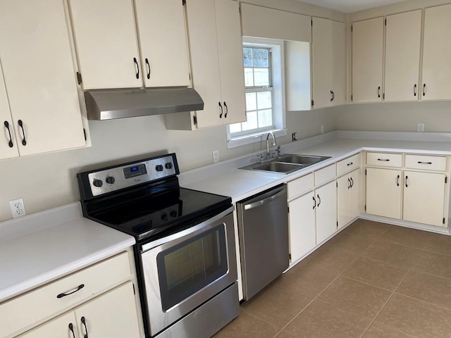 kitchen featuring white cabinetry, sink, stainless steel appliances, and tile patterned flooring