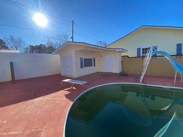 back of house featuring a patio and a fenced in pool