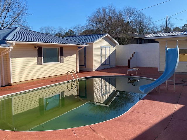 view of pool featuring a patio and a water slide