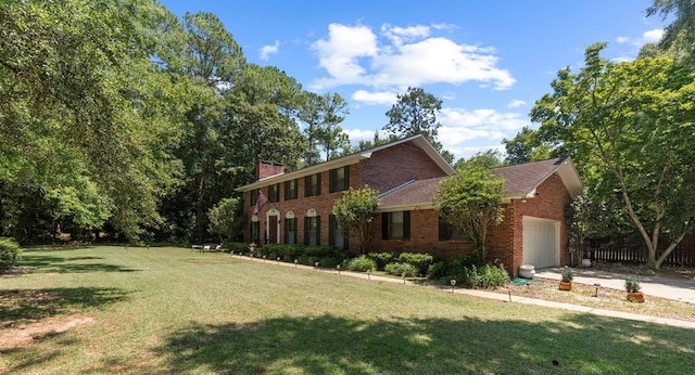 view of front of property with a garage and a front yard