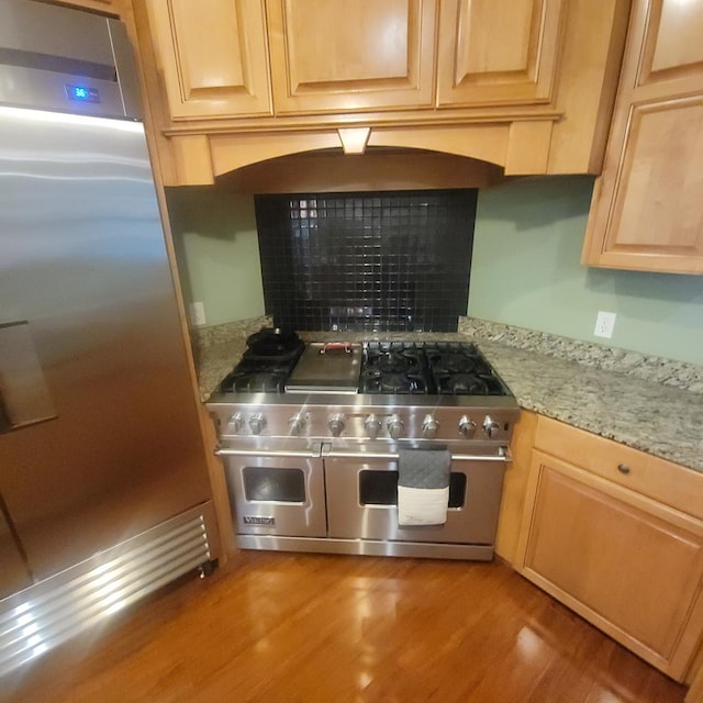 6325 State Highway 95, Abbeville, AL 36310 - kitchen with high quality appliances, light wood finished floors, a tile fireplace, and light stone counters