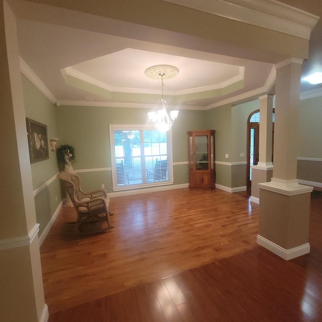 6325 State Highway 95, Abbeville, AL 36310 - sitting room featuring a raised ceiling, wood finished floors, crown molding, a chandelier, and ornate columns