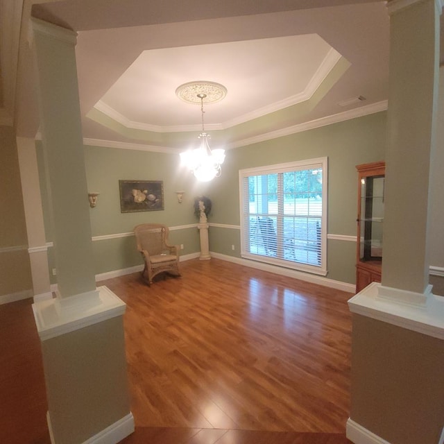 6325 State Highway 95, Abbeville, AL 36310 - unfurnished room with a raised ceiling, wood finished floors, ornamental molding, and a chandelier