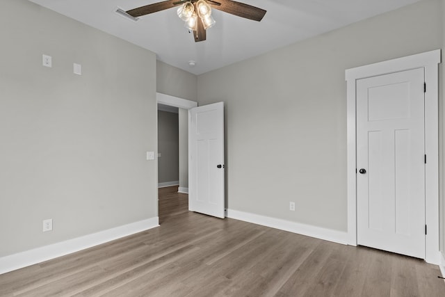 45 County Road 711, Enterprise, AL 36330 - unfurnished bedroom with light wood finished floors, baseboards, and a ceiling fan