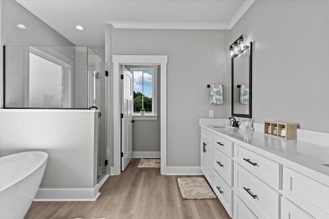 45 County Road 711, Enterprise, AL 36330 - full bathroom with baseboards, a shower stall, vanity, wood finished floors, and a soaking tub