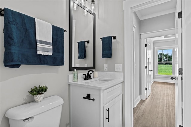 45 County Road 711, Enterprise, AL 36330 - half bath featuring toilet, wood finished floors, vanity, and baseboards