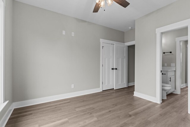 45 County Road 711, Enterprise, AL 36330 - unfurnished bedroom featuring wood finished floors, baseboards, ensuite bathroom, and ceiling fan