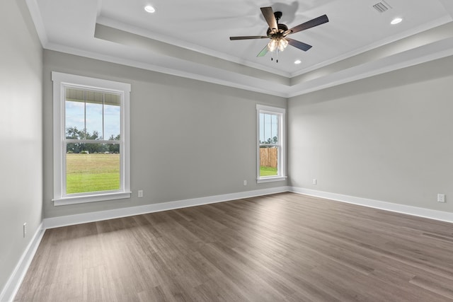45 County Road 711, Enterprise, AL 36330 - empty room featuring a raised ceiling, healthy amount of natural light, crown molding, dark wood-style flooring, and recessed lighting