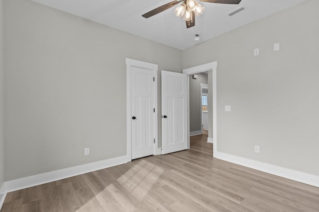 45 County Road 711, Enterprise, AL 36330 - unfurnished bedroom with light wood finished floors, baseboards, and a ceiling fan