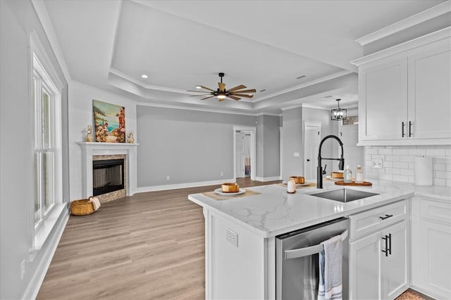 45 County Road 711, Enterprise, AL 36330 - kitchen featuring a sink, stainless steel dishwasher, a tray ceiling, a peninsula, and decorative backsplash