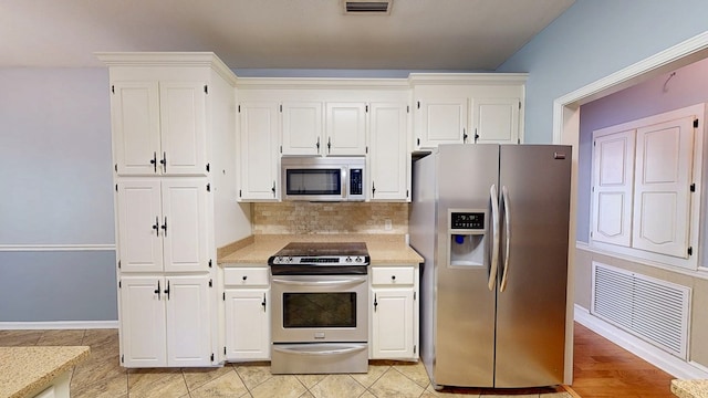 102 Eton Dr, Dothan, AL 36305 - kitchen featuring stainless steel appliances, light countertops, white cabinetry, and backsplash