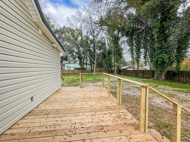 wooden terrace featuring a yard