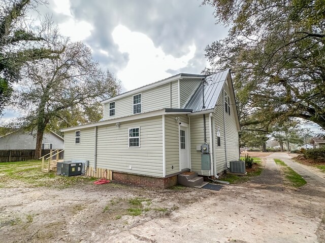 rear view of house with central AC