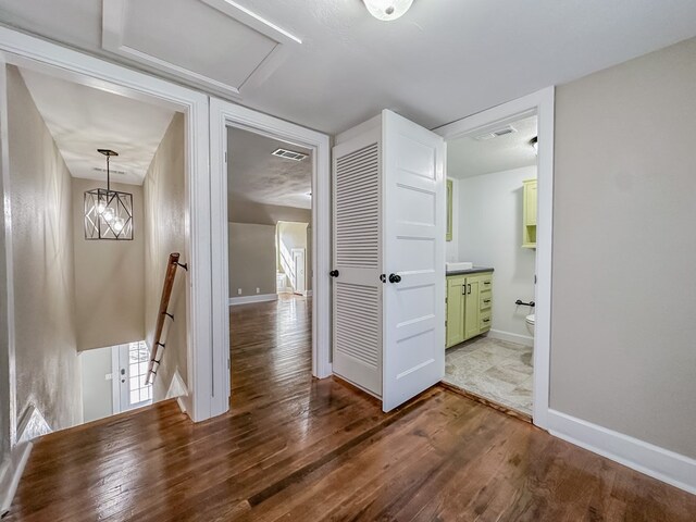 hall with hardwood / wood-style floors