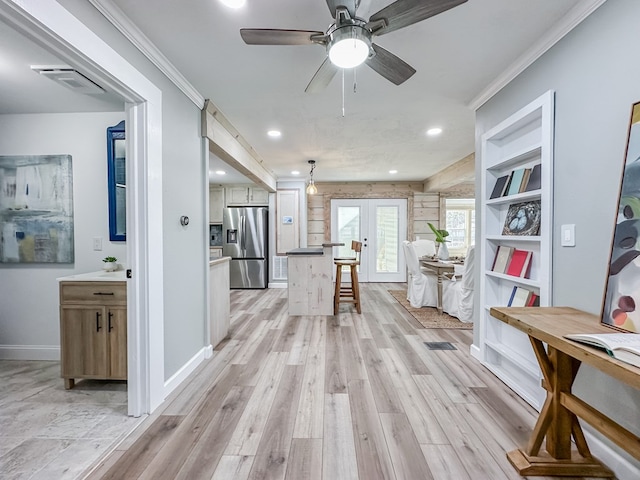 hallway featuring crown molding and light hardwood / wood-style flooring