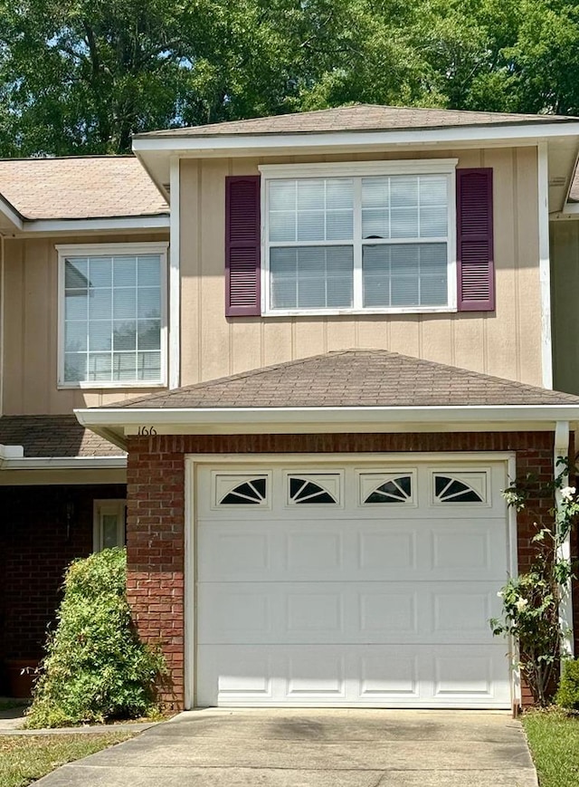 166 Candle Brook Dr, Dothan, AL 36303 - view of front of property featuring a garage, concrete driveway, brick siding, and board and batten siding