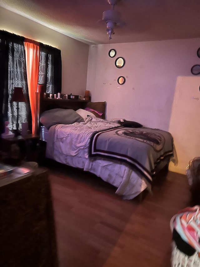 bedroom featuring wood-type flooring and ceiling fan