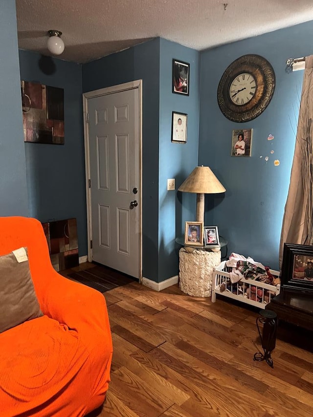 sitting room featuring hardwood / wood-style floors and a textured ceiling