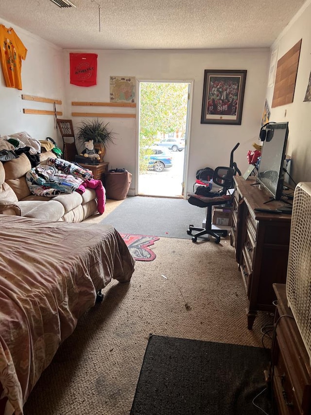 bedroom with carpet, a textured ceiling, and access to outside