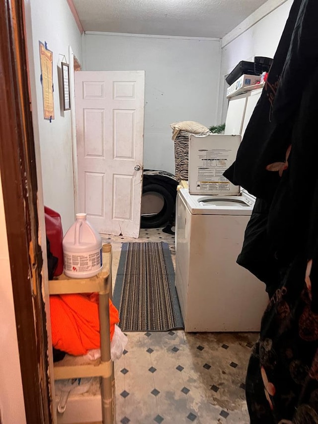 washroom with washer / dryer and a textured ceiling