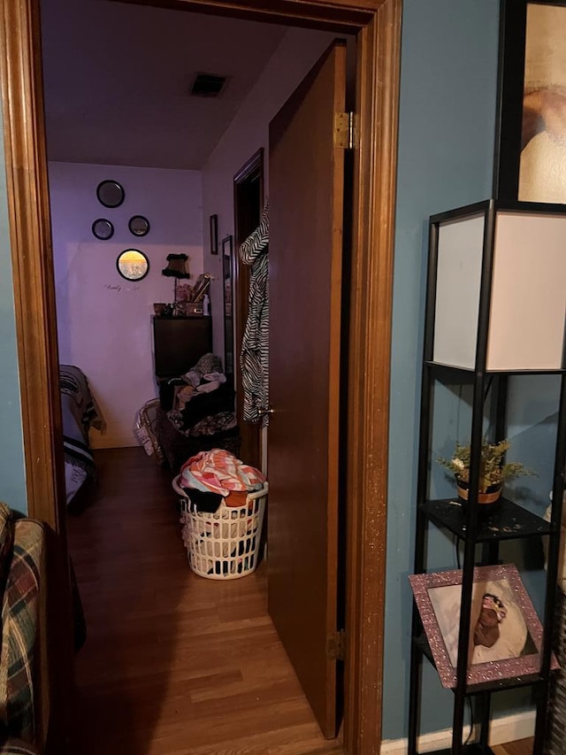 corridor with hardwood / wood-style floors