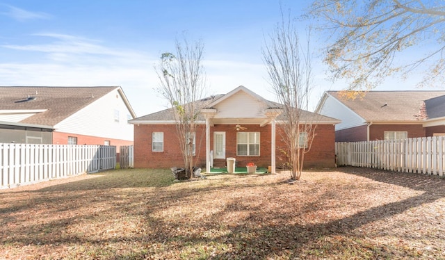 back of house featuring a yard and ceiling fan