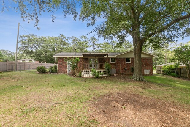 1571 Denton Rd, Dothan, AL 36303 - back of house featuring a fenced backyard, brick siding, and french doors