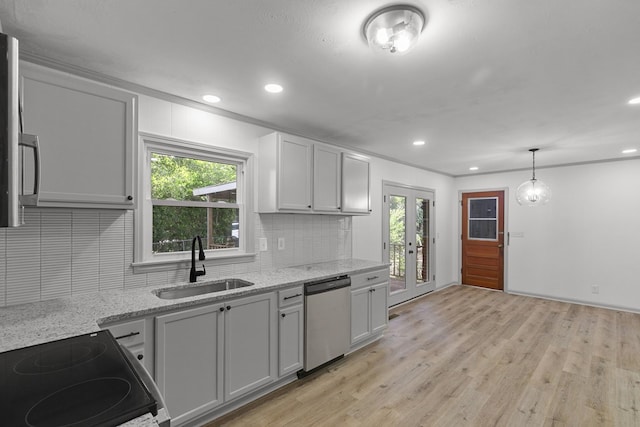 1571 Denton Rd, Dothan, AL 36303 - kitchen with dishwasher, stove, decorative backsplash, french doors, and light wood-type flooring