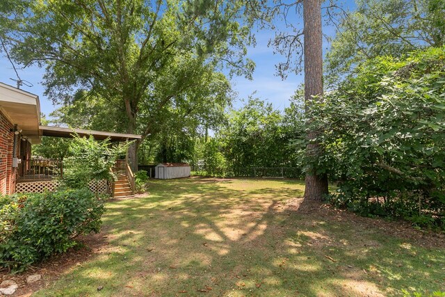 1571 Denton Rd, Dothan, AL 36303 - fenced backyard featuring a storage unit, stairway, and a deck